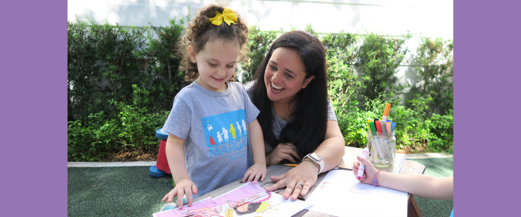 Teacher and Girl Playing on Table at a Preschool with Preschool Accreditation in Coral Gables, Coconut Grove, and South Miami