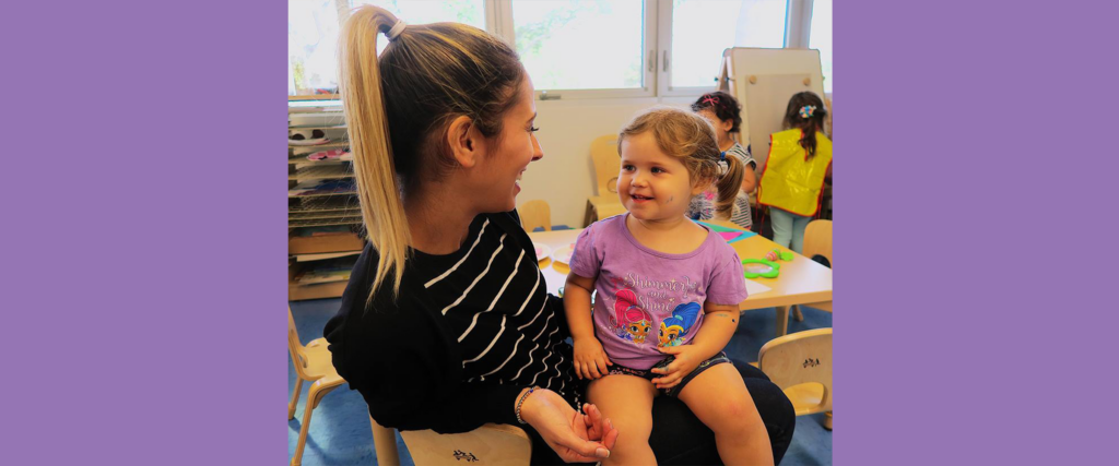 Child Sitting on Teachers Lap at Pre School for Pinecrest, FL, Coconut Grove, South Miami, Coral Gables