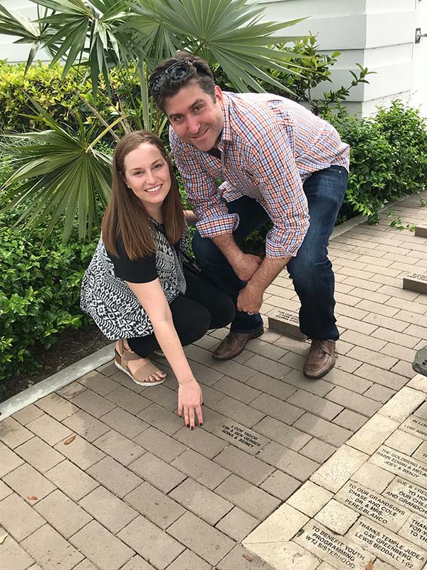 couple shows a brick at school