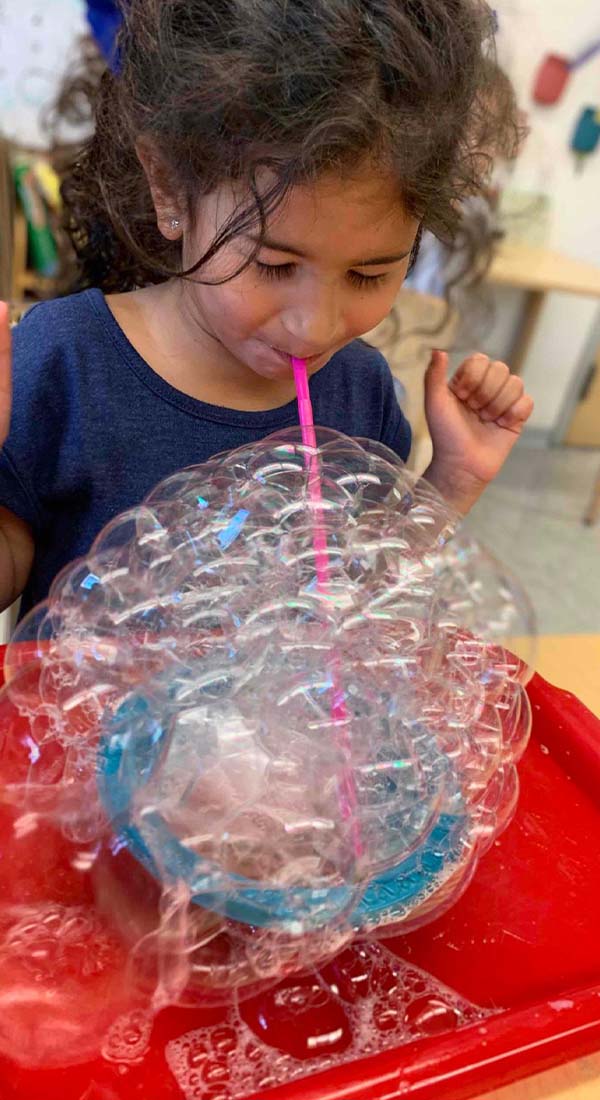 pre-k child blowing bubbles in VPK in Coconut Grove, South Miami, Pinecrest, FL, and Coral Gables