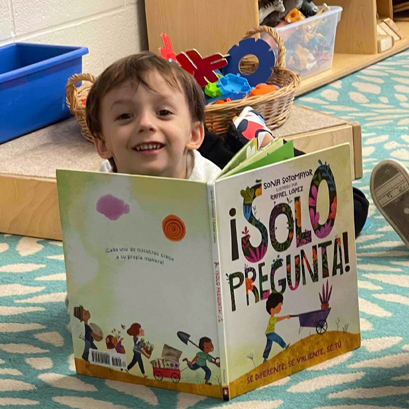 boy reading Spanish book