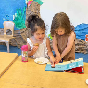 girls reading in Spanish class in preschool in Coconut Grove, FL