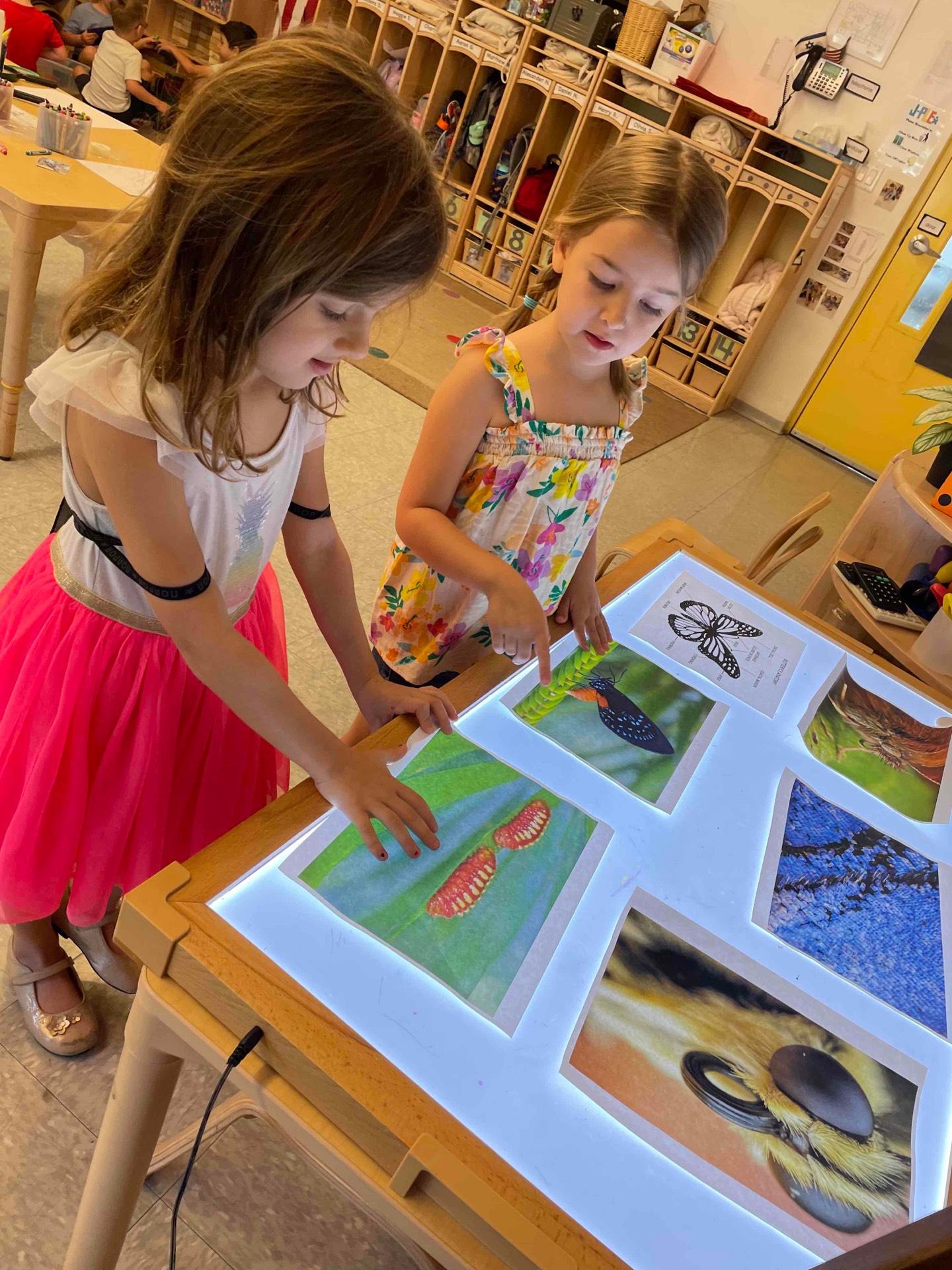 pre-k girls viewing art on lightable